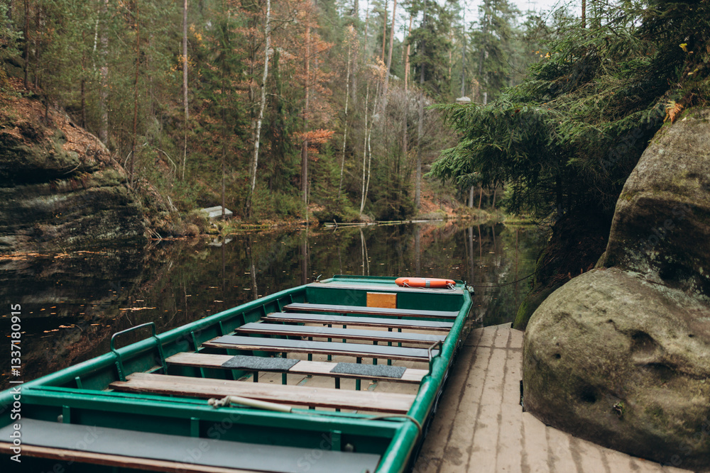 Boat with water reflection at a river pier. Texture of sandstone, The National park Adrspach Teplice rocks. High quality photo. Nature background