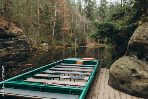 Obraz na płótnie Boat with water reflection at a river pier. Texture of sandstone, The National park Adrspach Teplice rocks. High quality photo. Nature background w salonie