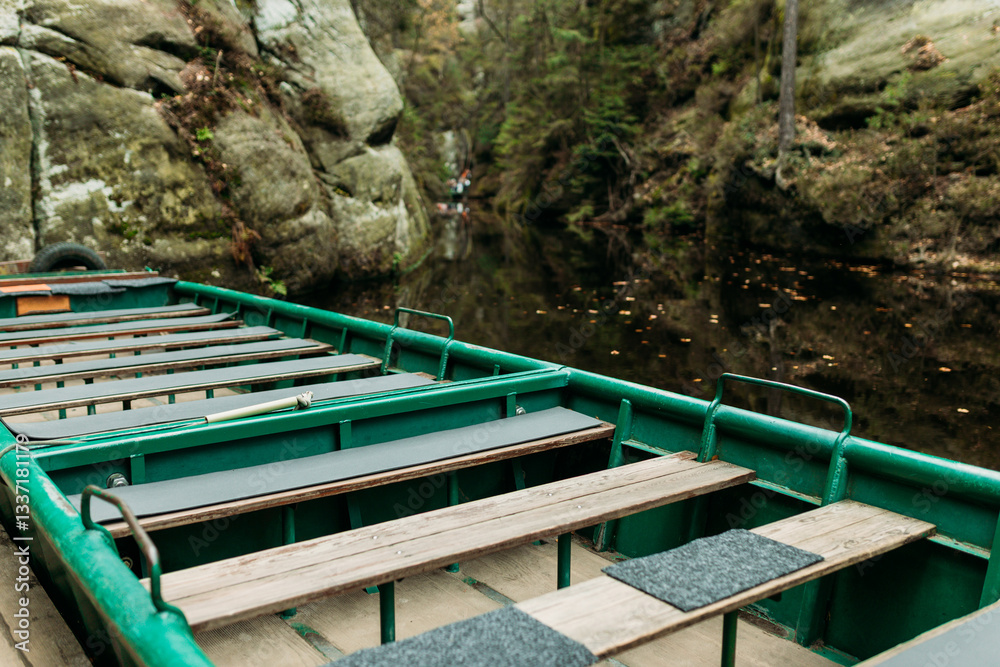 Boat with water reflection at a river pier. Texture of sandstone, The National park Adrspach Teplice rocks. High quality photo. Nature background
