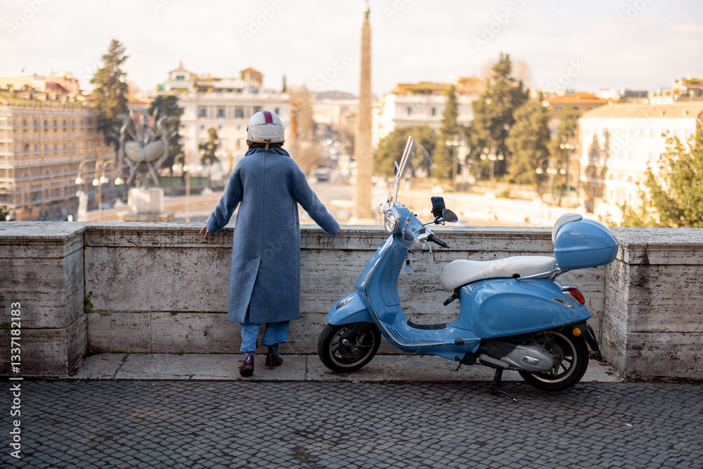 A stylish woman in a long blue coat and helmet stands, overlooking the historic cityscape of Rome with an obelisk in the background. Scooter parked nearby adds to the charm of Italian exploration