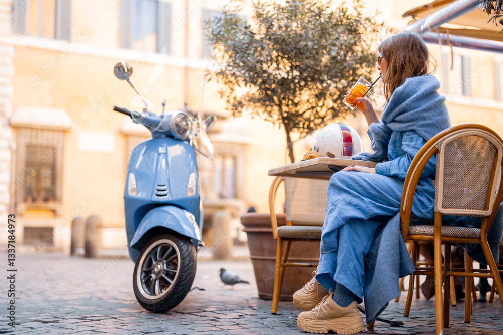 A fashionable Italian woman sits at a cozy outdoor cafe in Rome, sipping an aperitivo. Her scooter is parked nearby, adding to the effortless elegance of Italian city life