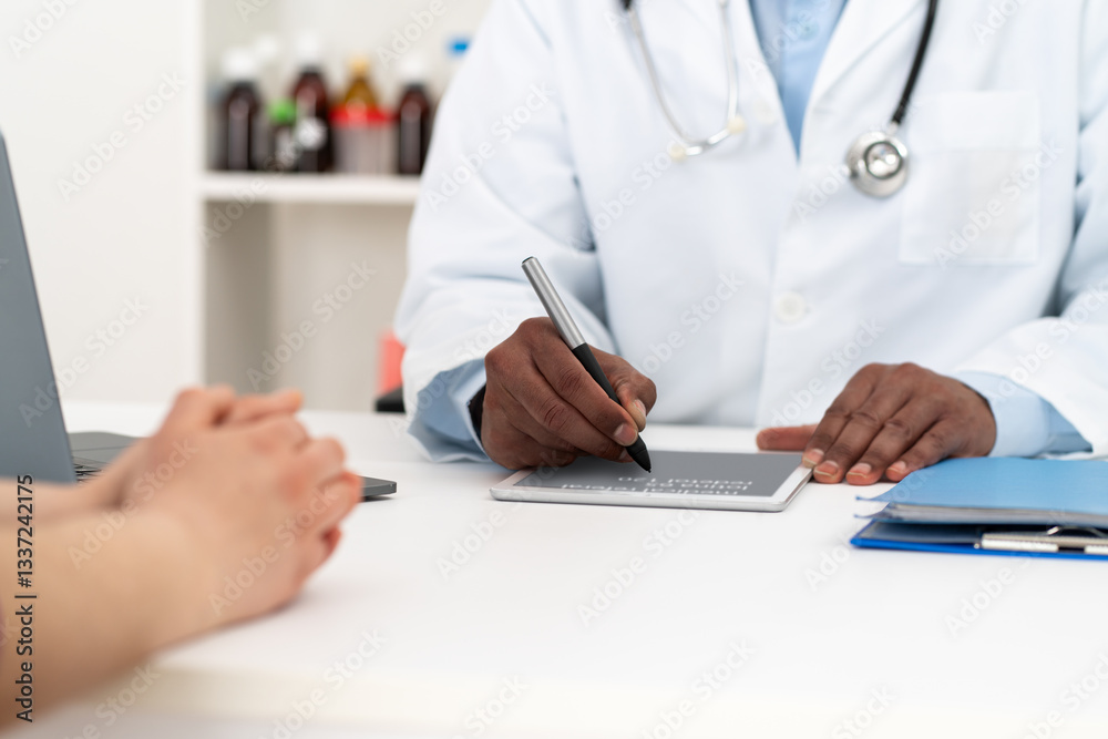 Doctor sitting at desk and writing with tablet prescription for his patient at hospital. Doctor sitting at desk and writing with tablet prescription for his patient at hospital.