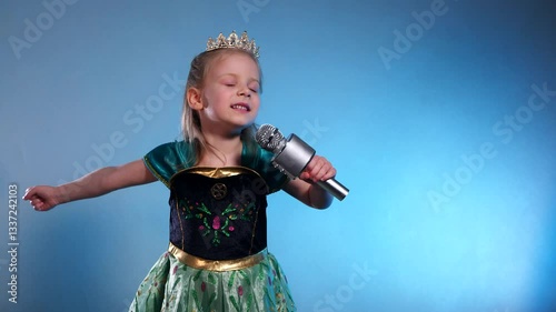 A little princess, voice soaring, a captivating performance. The Queen sings into the microphone and dances. Karaoke. Emerald gown, sparkling crown, a tiny starlet takes the stage. Hands clasped 