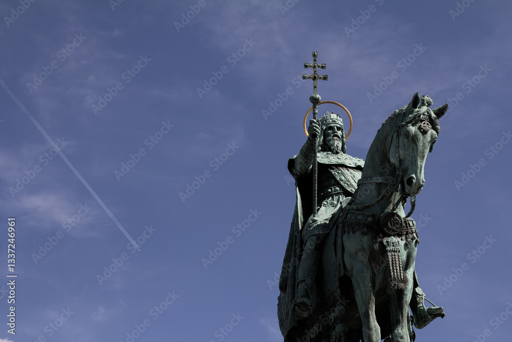 The Statue of St. Stephen in Budapest with a plane flying in the background, highlighting the blend of history and modernity. The Statue of St. Stephen in Budapest with a plane flying in the background, highlighting the blend of history and modernity.