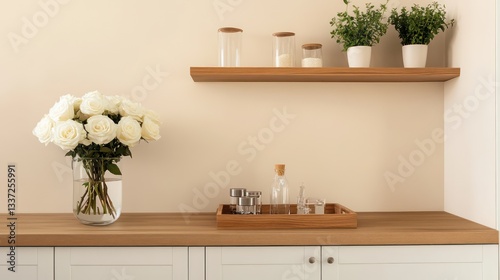 A minimalist kitchen featuring white cabinets and warm oak countertops