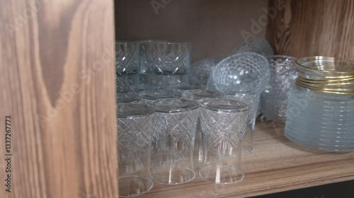 Taking Glasses from a Kitchen Cabinet – Close-Up Hand Action in Modern Home Interior