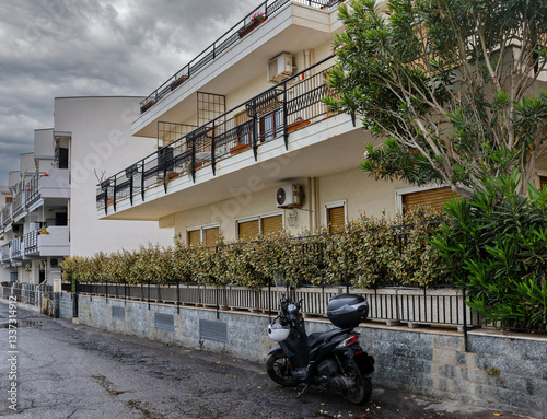 Traditional Sicilian apartment home with motorcycle sitting in front