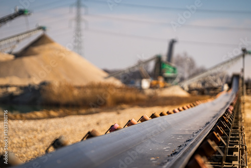 Obraz na płótnie heavy duty conveyor belt - open pit mine and sand mining in the background - raw material transport w salonie