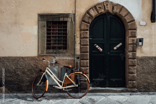 Obraz na płótnie Old cozy street with parked bicycle in Lucca, Italy. Lucca is a city and comune in Tuscany. It is the capital of the Province of Lucca w salonie