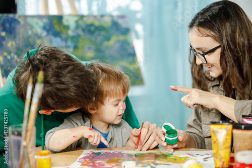 Young family with their son painting and having fun in the room