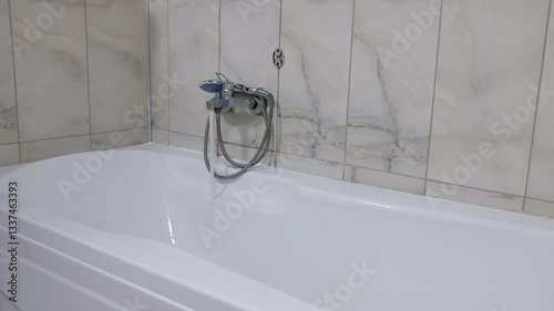 Water Filling Bathtub in Modern Bathroom Scene with Flowing Tap