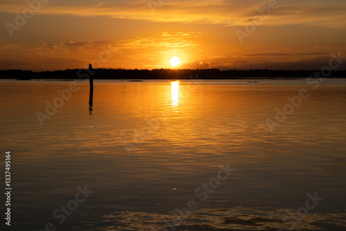 Obraz na płótnie tramonto su una laguna in un ambiente marino tranquillo, nella regione Veneto, con cielo sereno, in estate, che si riflette sull'acqua w salonie