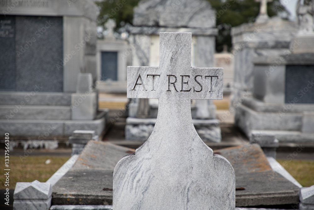 A granite gravestone memorial states At Rest in the Saint Louis Cemetery Number Three in New Orleans, Louisiana.