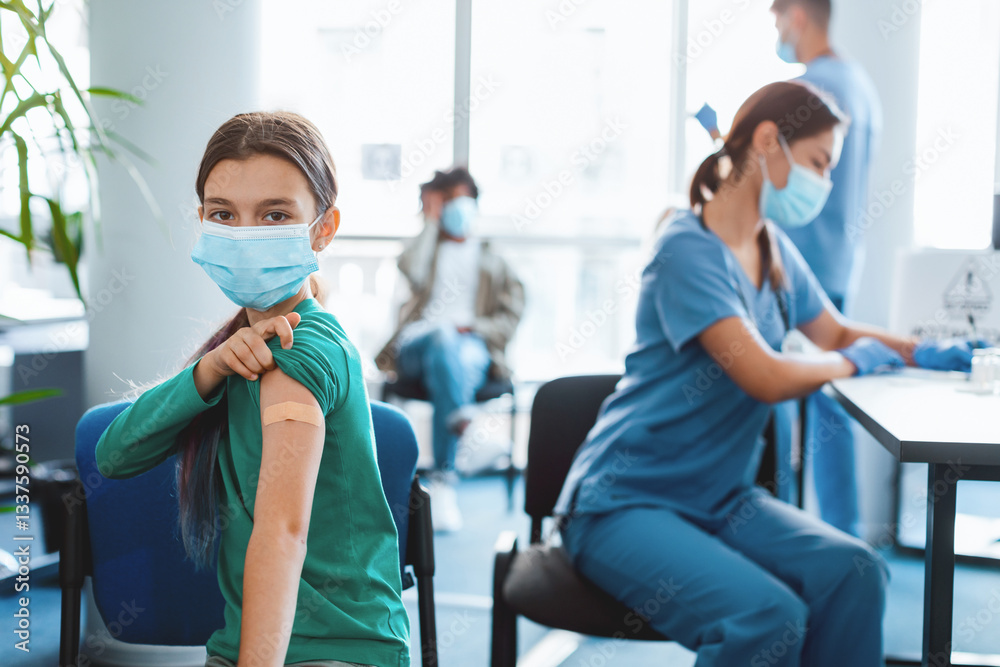 Obraz premium Children and a nurse participate in a vaccination campaign at a clinic. A young girl smiles with a bandage on her arm after receiving the flu shot, promoting health awareness.
