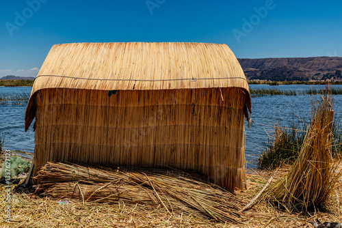 House on Uros floating island made of reed on Titicaca lake, Peru photo