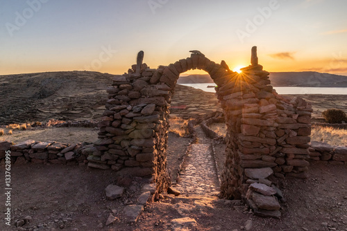 Sunset view of a stone gateway on Pachatata hill on Amantani island in Titicaca lake, Peru photo