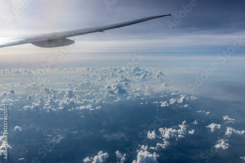 View of an airplane wing above clouds