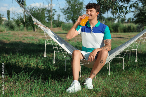 Young man with bottle of le...