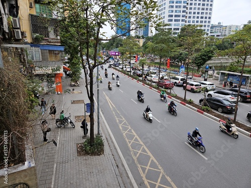 A busy urban street in Ha Noi city, Vietnam with cars, buses, and numerous motorbikes navigating through traffic in Ha Noi, Vietnam, Feb 7, 2025.