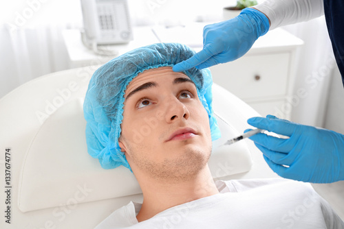 Young man receiving injecti...