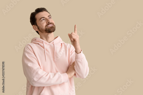 Handsome man pointing at so...