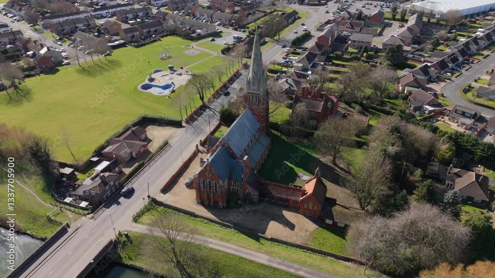 Aerial view of small town and church along a river in England UK Europe on a sunny day traffic crossing bridge countryside Aerial view of small town and church along a river in England UK Europe on a sunny day traffic crossing bridge countryside
