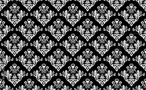 Wallpaper in the style of Baroque. White and black floral ornament. Seamless vector background. Graphic pattern for fabric, wallpaper, packaging. Ornate Damask flower illustration.