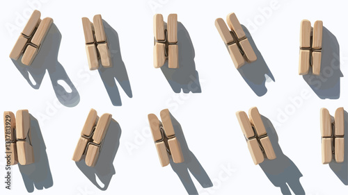The image shows a flat lay, top-down view of multiple identical small, light brown wooden objects arranged in a grid-like pattern on a white background.  Each object appears to be composed of two