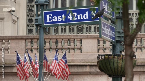 New York City Grand Central Terminal, 42 street, Park Avenue, Pershing Square architecture. Midtown district railroad hub, railway transport. NY crossroad corner, intersection road sign, american flag