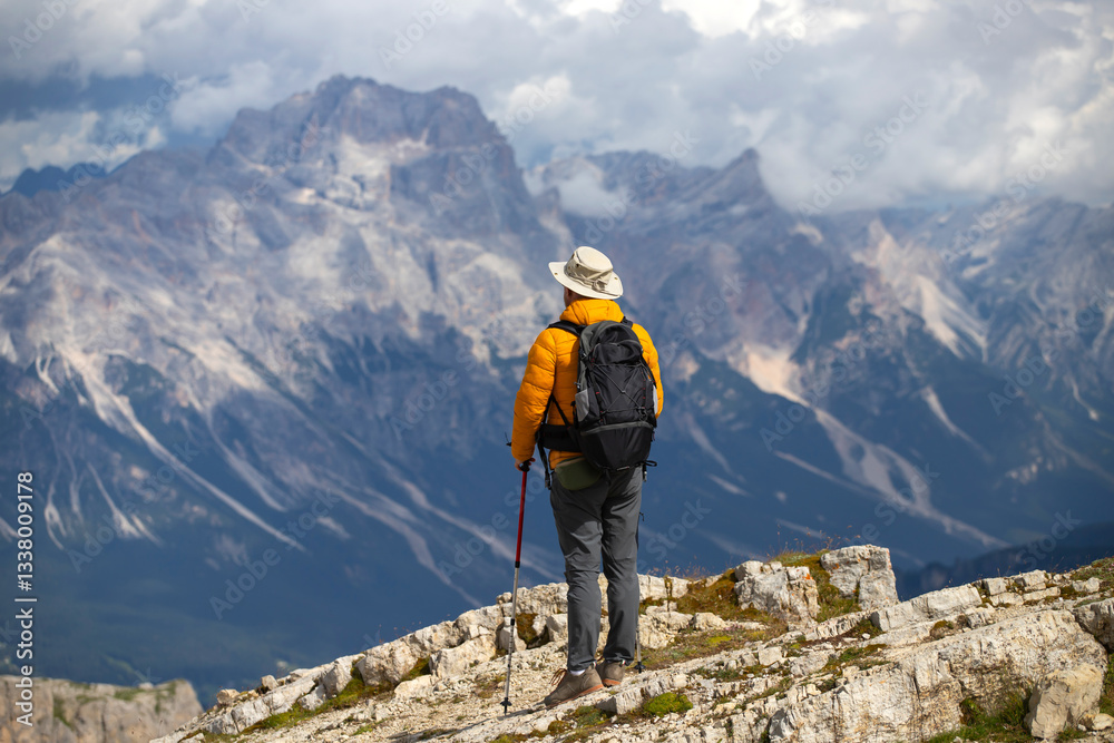 Fototapeta premium Hiker enjoys the view from Lagazuoi mountain over the italian Dolomites.