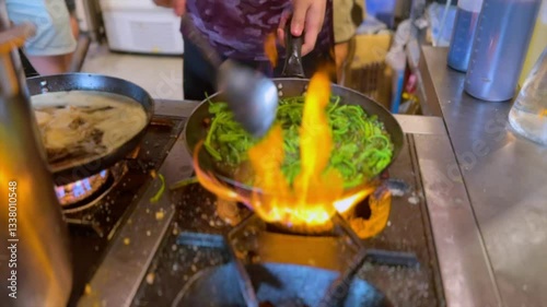 Stir Fried Morning Glory Cooking on Open Flame in a Street Food Kitchen