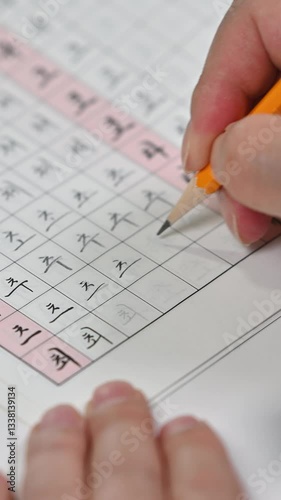 한글 쓰기 연습하는 손과 연습장