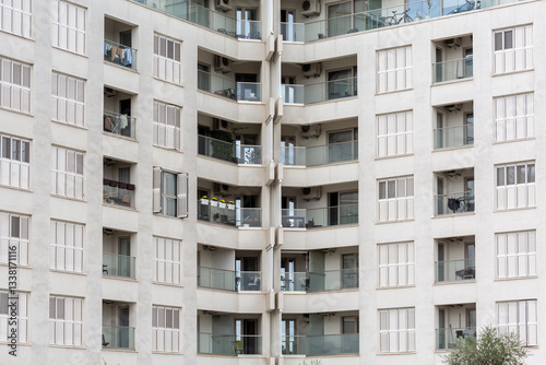  Modern urban apartment building with balconies and windows, residential architecture and city living concept