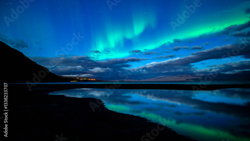 Northern lights dancing over calm lake in Torne trask. Abisko national park in north of Sweden.