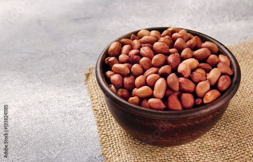 Organic Raw Peanuts in a Bowl on grey table