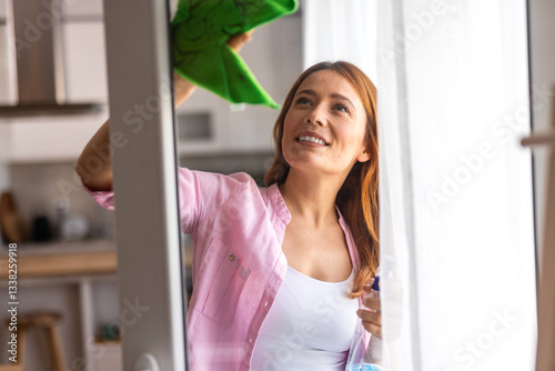 housework and housekeeping concept - happy woman in cleaning window with rag and cleanser spray at home Free Download housework and housekeeping concept - happy woman in cleaning window with rag and cleanser spray at home - GFXLoad