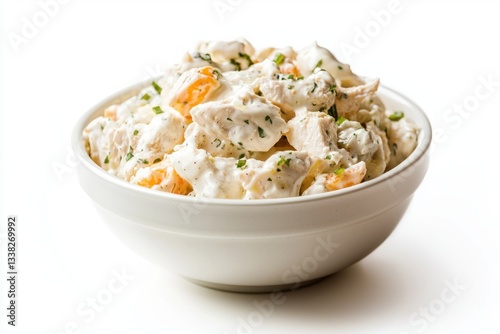 Delicious homemade chicken salad with mayonnaise dressing in ceramic bowl on white background