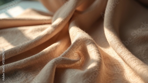 Light brown fabric texture bathed in gentle, diffused light, creating delicate shadows and emphasizing the material's weave.