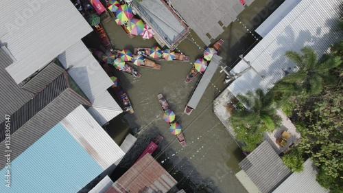 Rotating aerial drone shot of Damnoen Saduak Traditional floating market with tourists on boats in Damnoen Saduak, Ratchaburi, Thailand close to Bangkok
