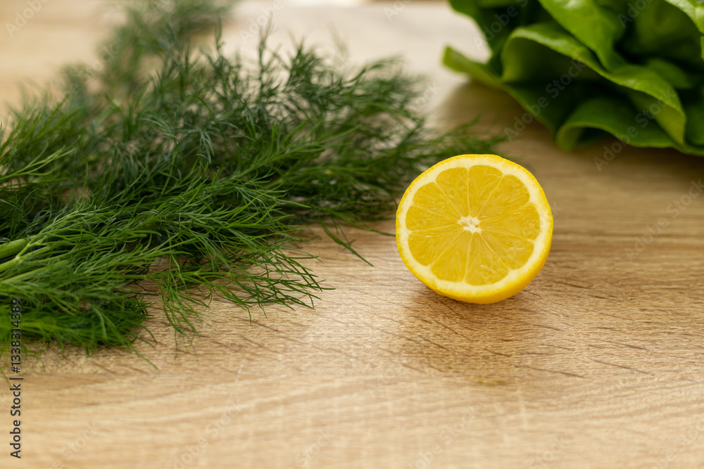 Lemon, dill close-up on the table. Ingredients for salad. Healthy food Lemon, dill close-up on the table. Ingredients for salad. Healthy food