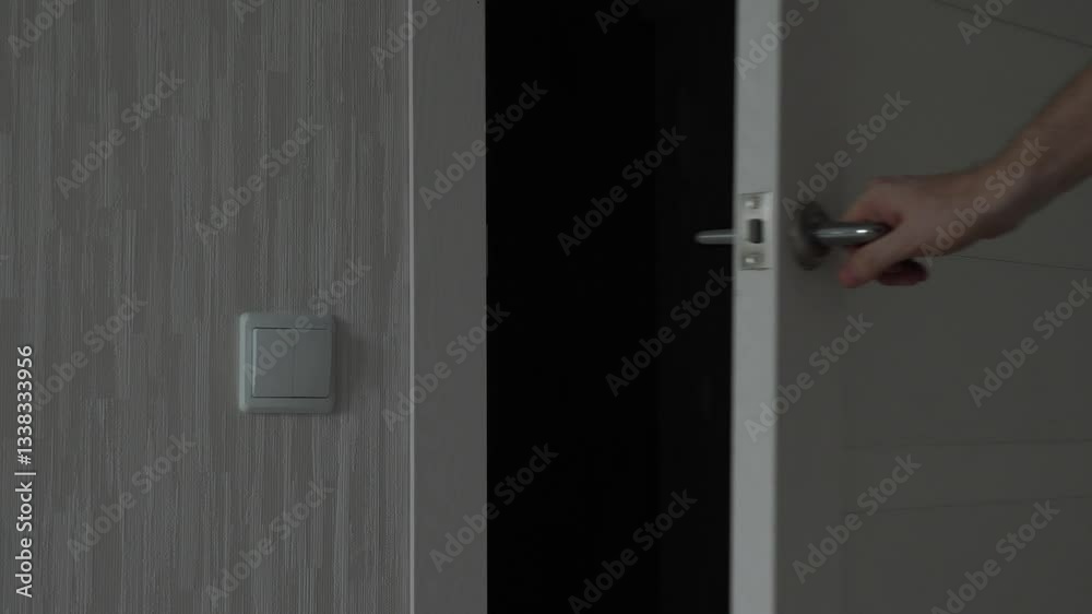 a man opens and closes a metal interior door from the inside using the door handle
