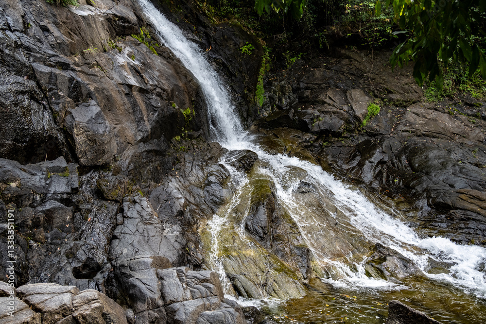 beautiful landscape with a waterfall and mountains and forest on a sunny day in Thailand beautiful landscape with a waterfall and mountains and forest on a sunny day in Thailand