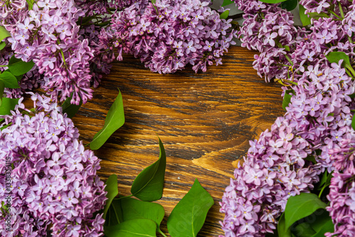 Beautiful spring flowers lilac on a wooden vintage board with place for text. Syringa vulgaris. Happy Mother's Day greetings card.