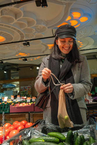 Obraz na płótnie Woman Shopping for Cucumbers with Reusable Bag w salonie