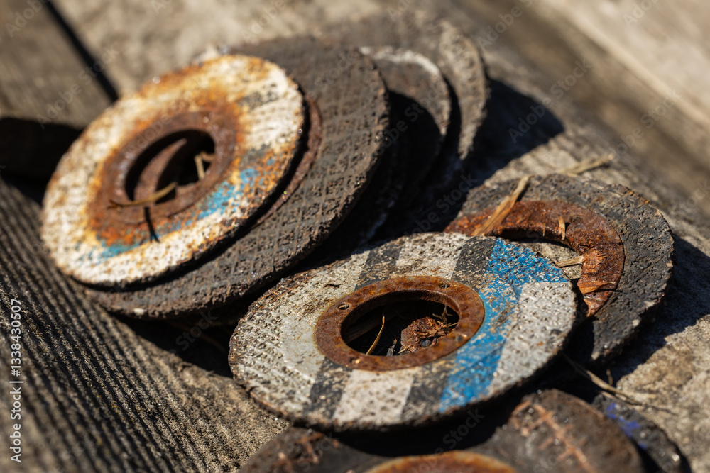 Old cutting discs for grinder tool, circular metallic discs with hole in center exposed to moisture Old cutting discs for grinder tool, circular metallic discs with hole in center exposed to moisture