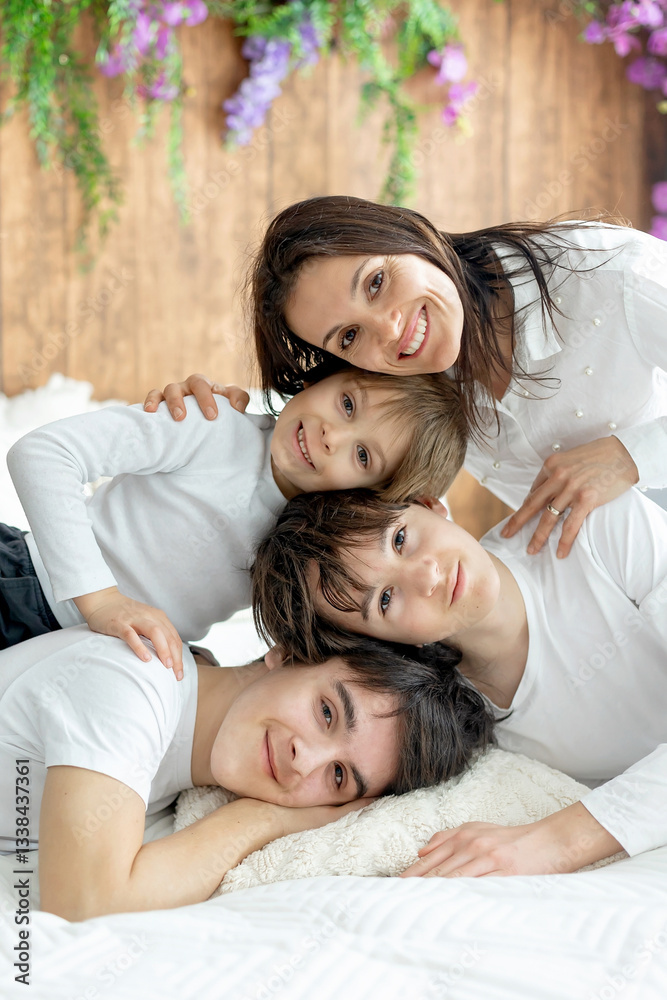 Fototapeta premium Portrait of mother and her children at home in bed