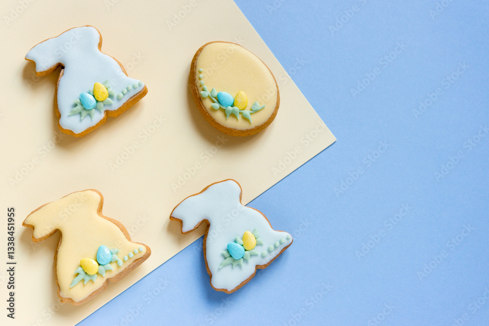 Fototapeta premium Easter homemade baked gingerbread with different pattern of icing or cookies in the shape of bunny and eggs. Light background, top view, copy space