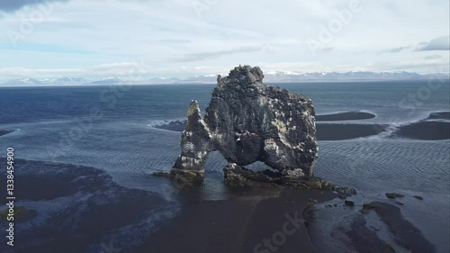 aerial footage of Hvitserkur huge troll stone on iceland shore