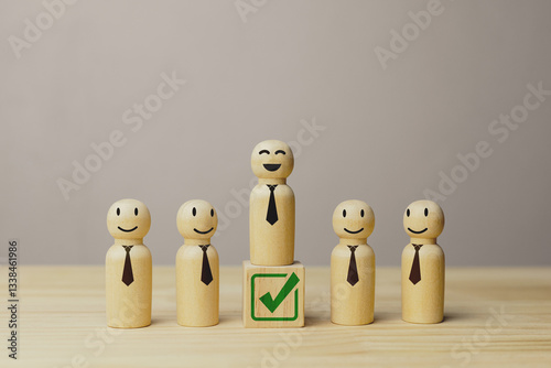 A wooden doll on block with check mark icons. Concept of human resource management, selection of outstanding leaders, and process of selecting candidates to join the organization.
