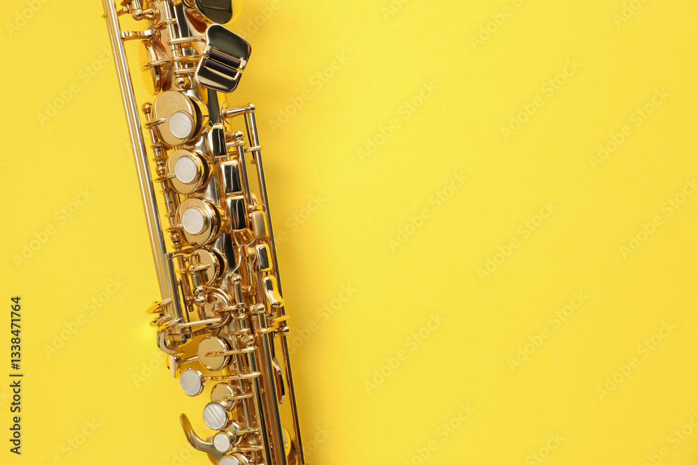 Naklejka premium Jazz. One saxophone on yellow background, top view. Space for text